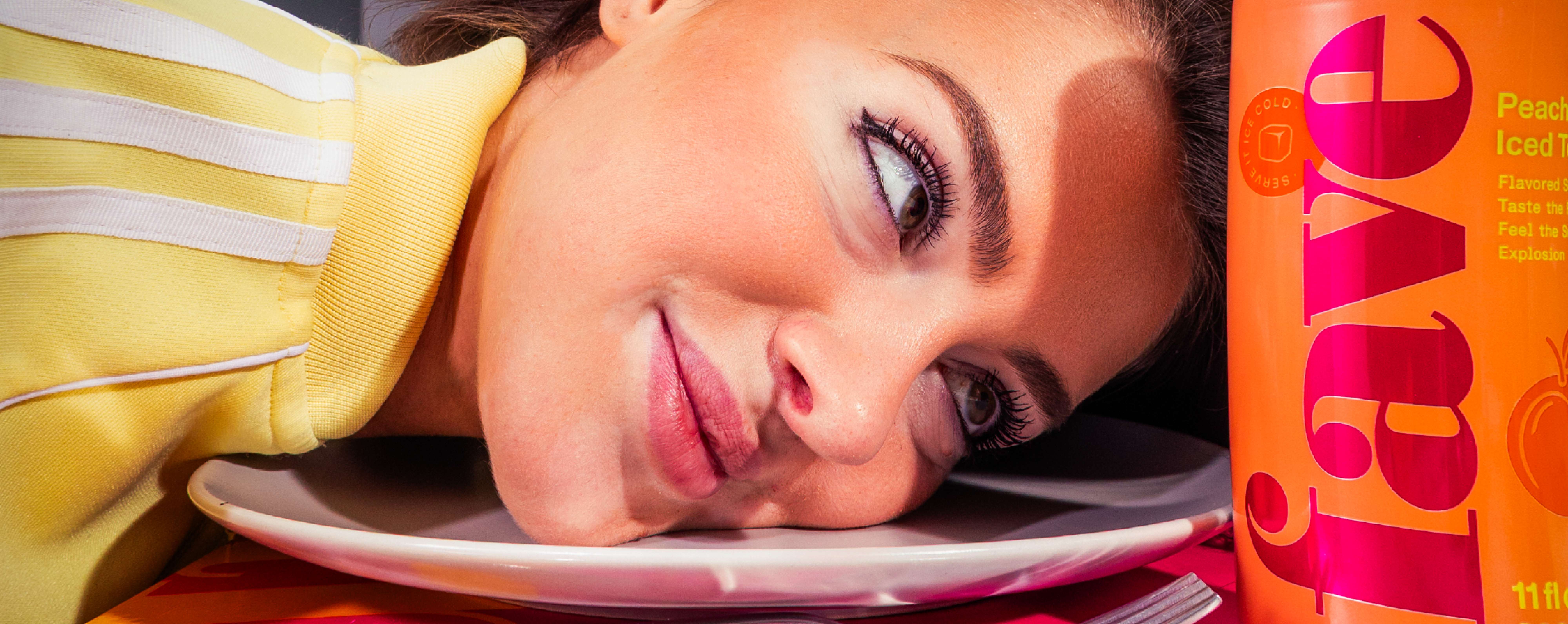 Fave Peach Iced Tea lifestyle — model with orange can