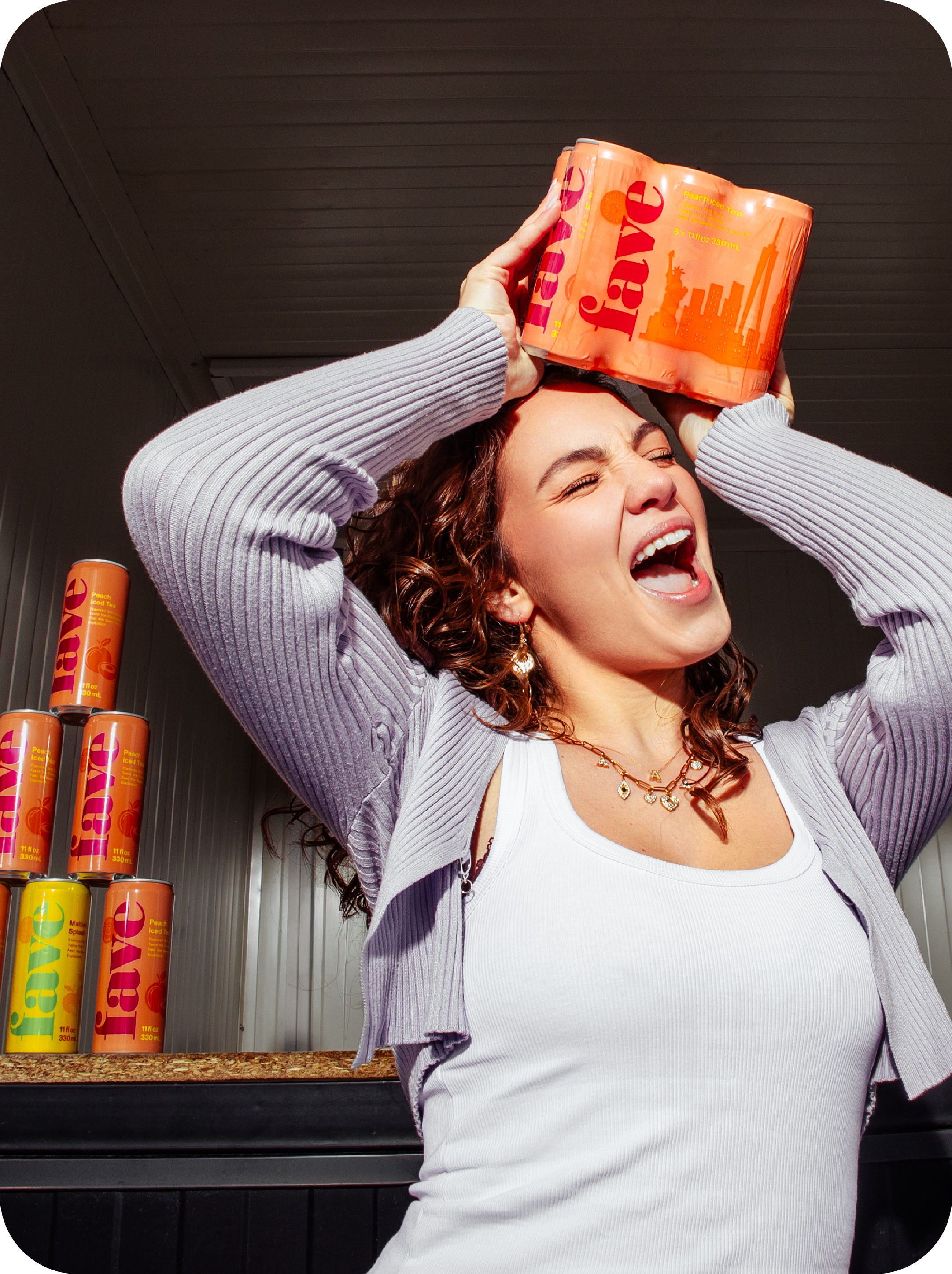 Woman balancing a six-pack of Fave on her head