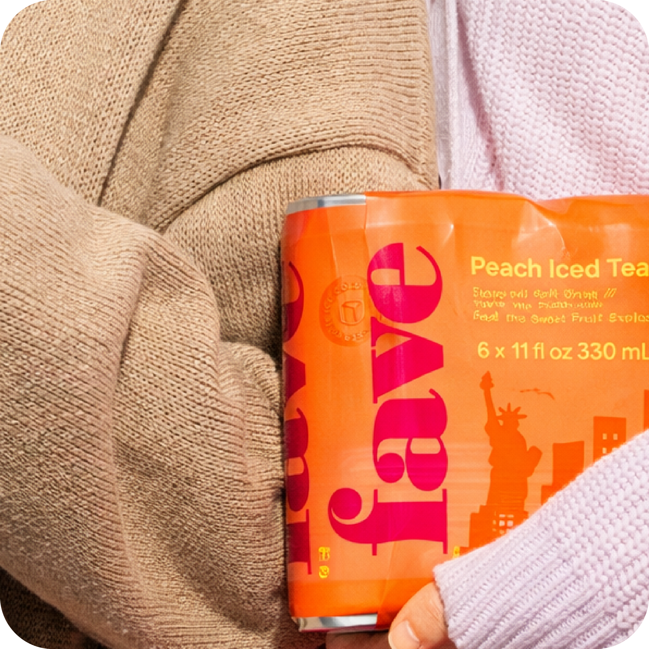Holding a Fave Peach Iced Tea six-pack